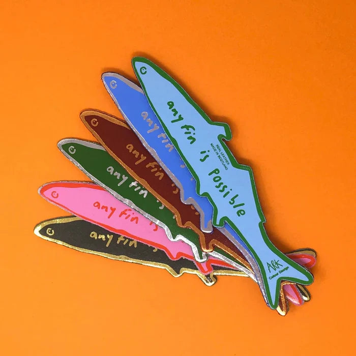 Colorful fish-shaped bookmark with 'any fin is possible' text on an orange background