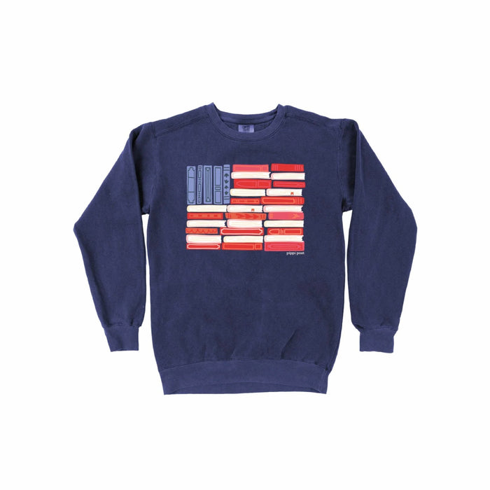 Navy blue sweatshirt with American flag design made out of books on a white background.