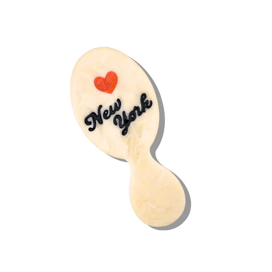 Wooden hairbrush with 'New York' and heart design on a white background