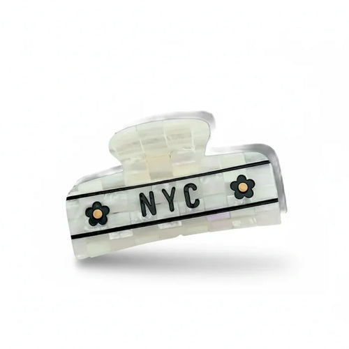 Hair clip with 'NYC' and floral designs on a white background