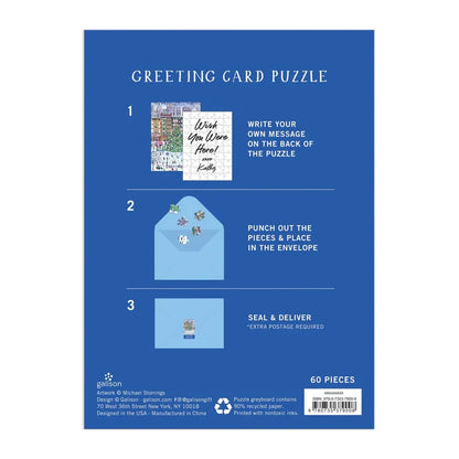Blue packaging card for a greeting card puzzle, showing step-by-step instructions with small illustrations of the included pieces and envelope, plus text indicating 60 pieces.