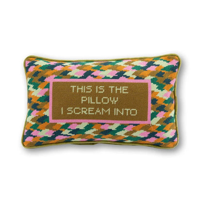 Colorful pillow with text 'This is the pillow I scream into' on a white background