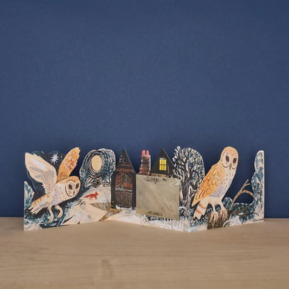 The back view of an opened three-panel die-cut card featuring a winter nocturnal scene with barn owls, a fox, and a central panel marked "Message" for writing.