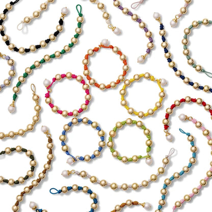 Colorful beaded bracelets on a white background