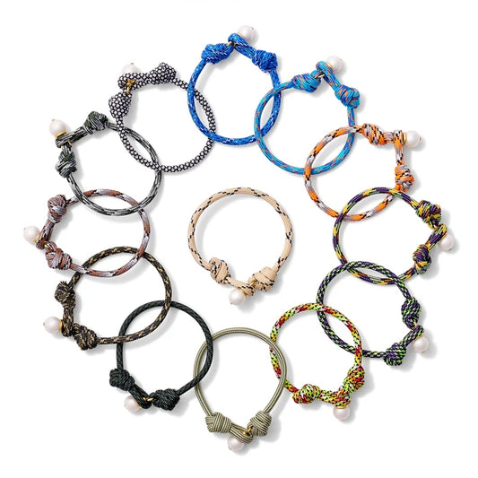 Collection of colorful braided bracelets on a white background